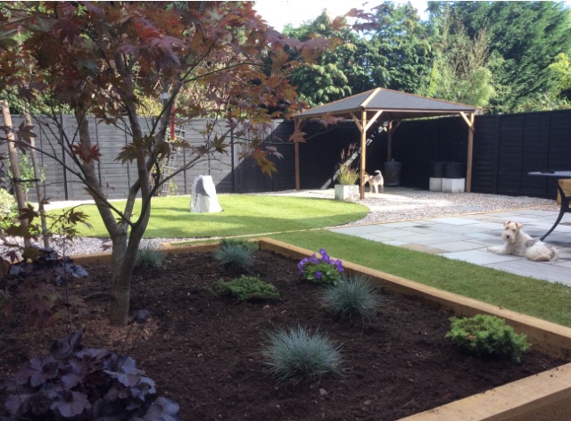 view of garden with raised bed, Gazebo ans Stone Feature in lawn