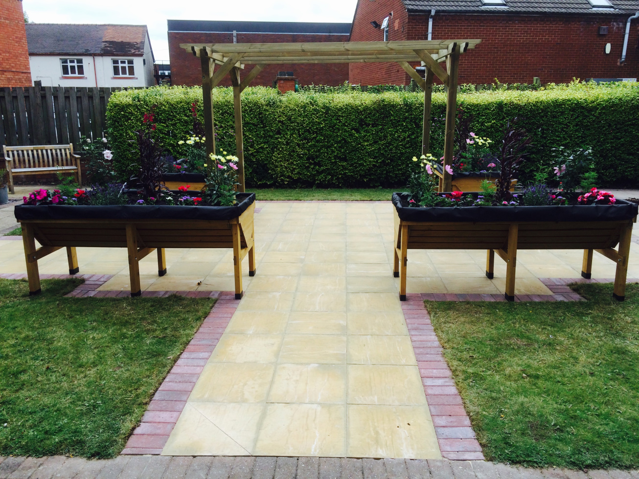 image of a pergola with 2 large free standing planters in the foreground